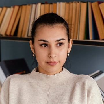 Woman holding books in a library setting